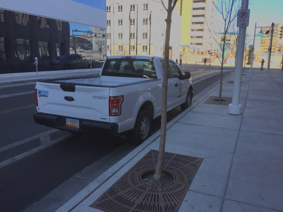 Albuquerque city planning department pickup, parked in a bike lane next to a 