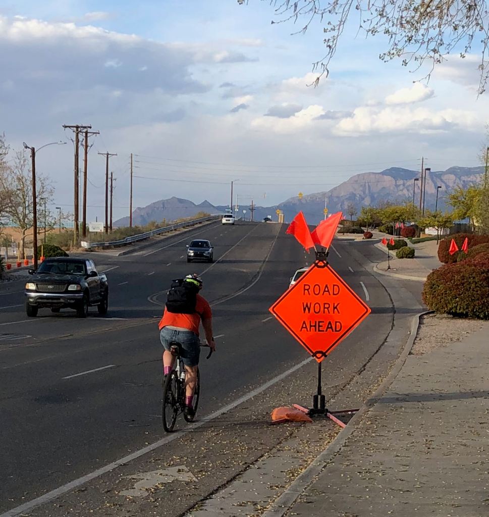 bicycle detouring around road work sign blocking bike lane