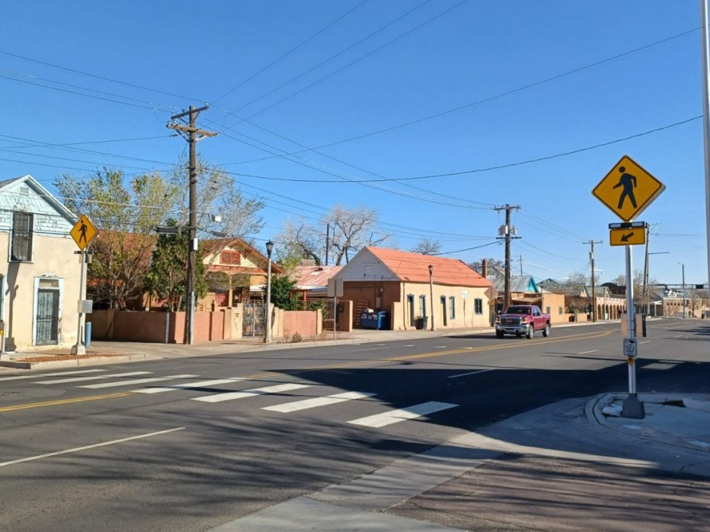 Crosswalk across street with warning sign.